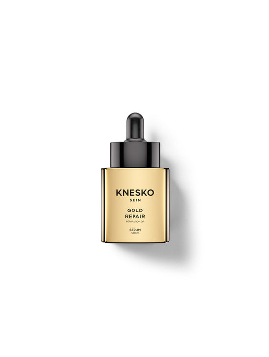 Knesko Skin Gold Repair Serum in a square gold bottle with a black dropper cap, centered on a white background with a soft shadow.