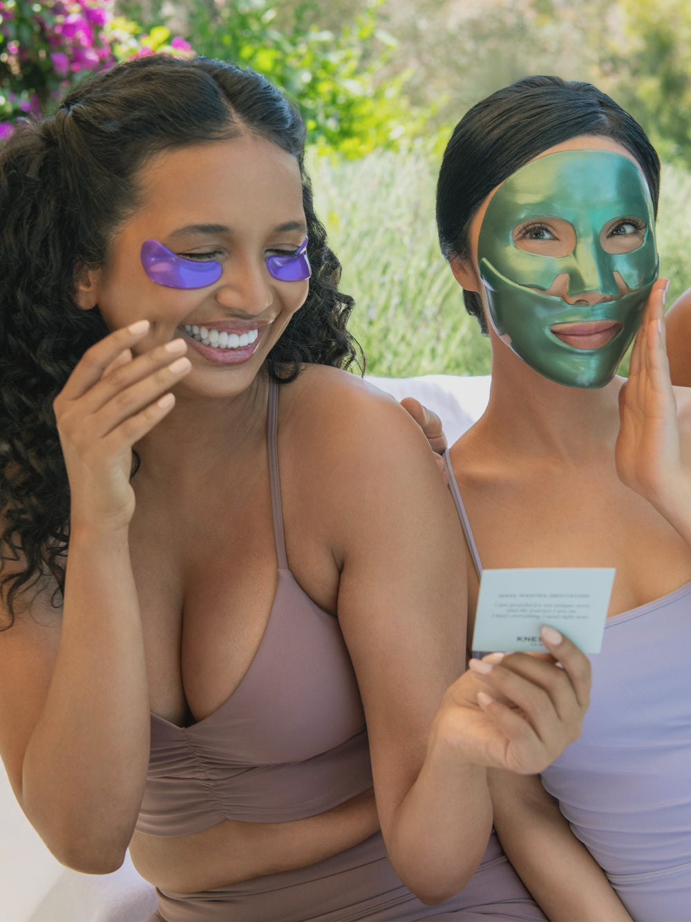 Two women outdoors one with eye masks and one with face masks