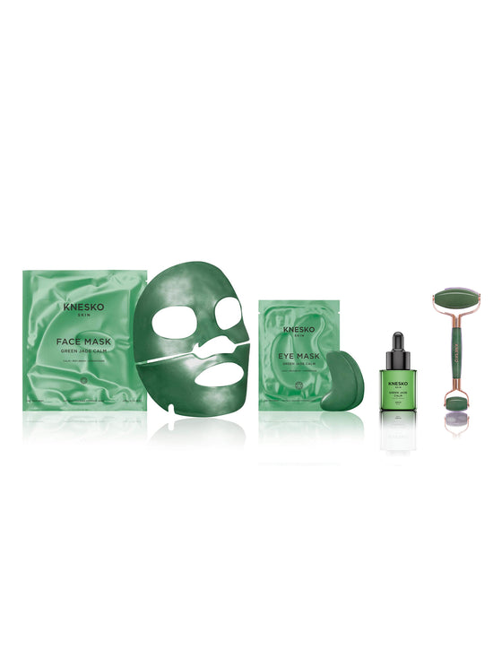 Set of green skincare products including a face mask, eye mask, serum, and roller on a white background.