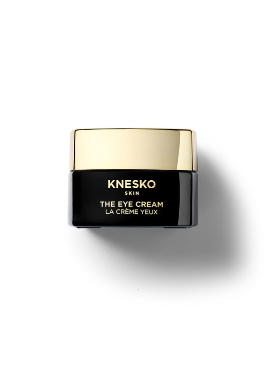 Knesko eye cream jar with gold lid on a white background