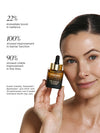 Woman holding the face oil bottle with text about it's benefits