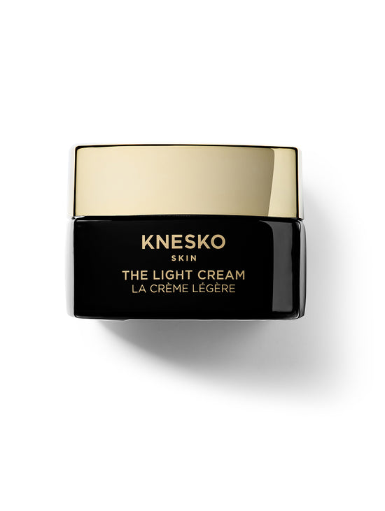 Knesko The Light Cream jar with gold lid on a white background