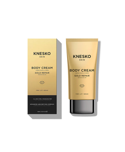 Knesko Skin Body Cream in Gold Repair, shown as a gold squeeze tube with a black cap next to its matching gold and black packaging box on a white background.