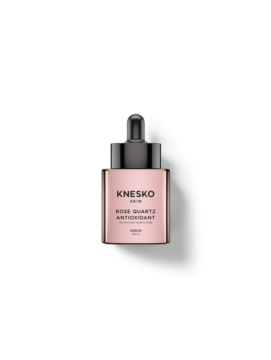 Knesko Skin Rose Quartz Antioxidant Serum in a rectangular dropper bottle with a metallic rose gold body and a black dropper cap, centered on a white background with a soft shadow.