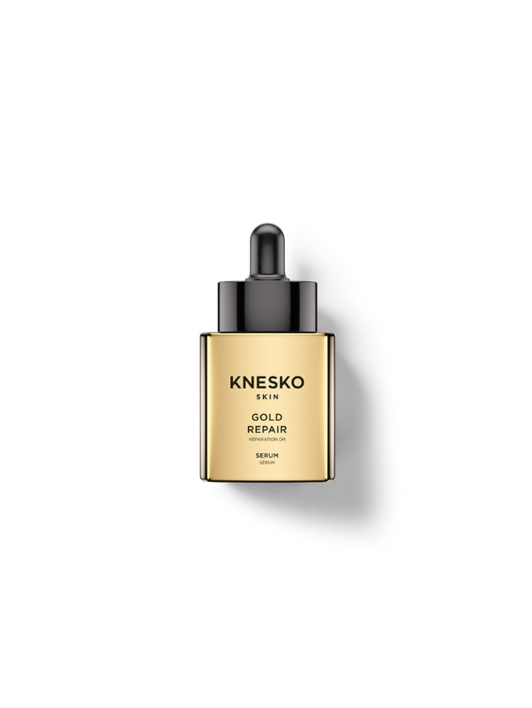 Knesko Skin Gold Repair Serum in a square gold bottle with a black dropper cap, centered on a white background with a soft shadow.