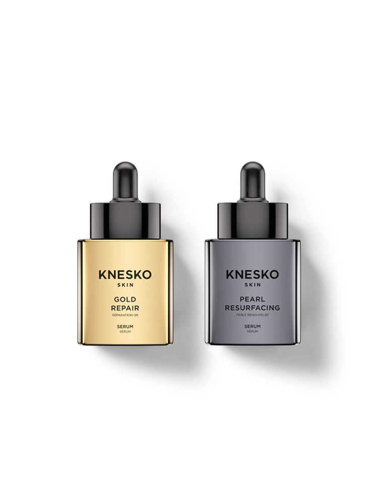 Two Knesko Skin serum dropper bottles on a white background, one with a gold-toned bottle labeled Gold Repair and the other with a dark gray bottle labeled Pearl Resurfacing.