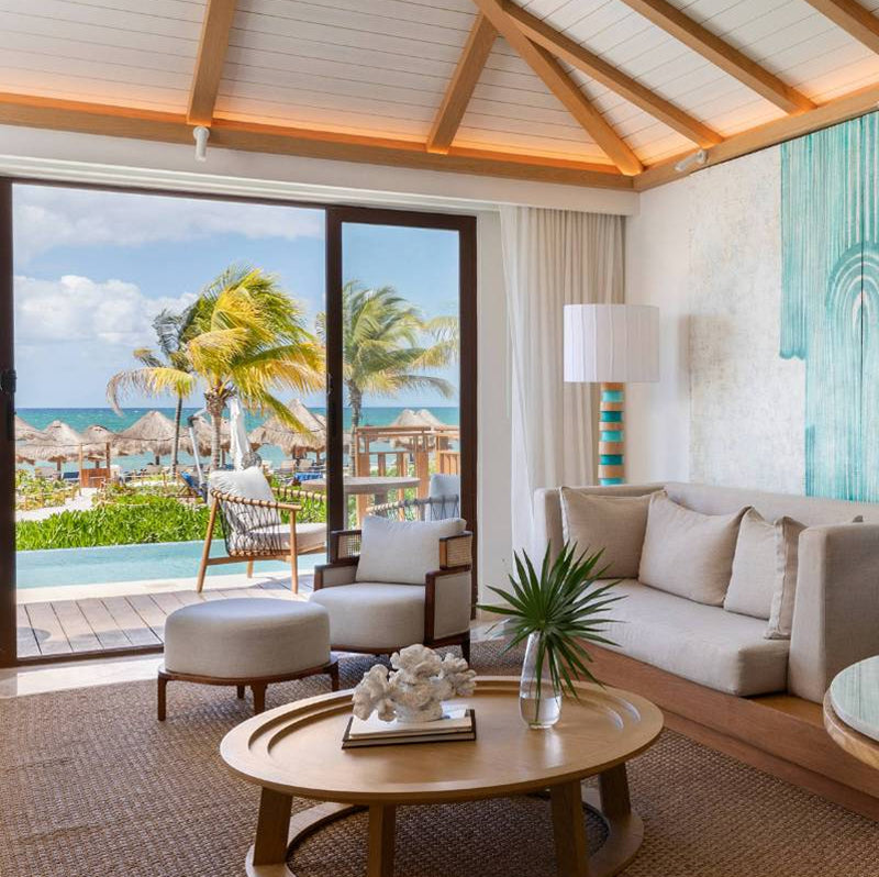 Luxury room with ocean view and outdoor deck.