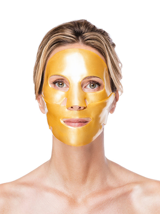Woman wearing a gold face mask against a white background
