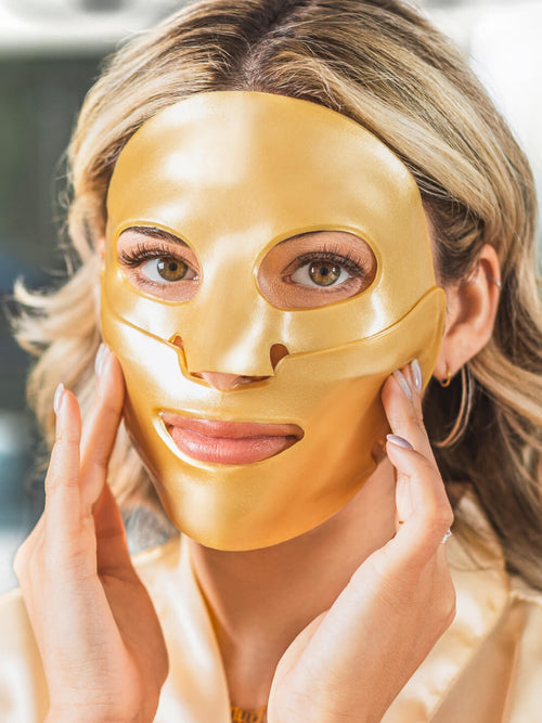 Gold face mask knesko on a beautiful woman