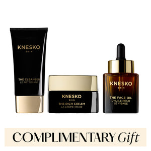 Knesko skincare products including cleanser, cream, and face oil on a white background with 'Complimentary Gift' text.