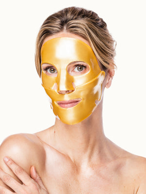 Woman wearing a gold face mask against a white background